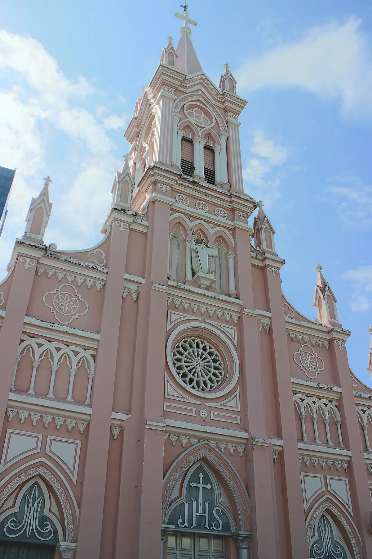 The pink facade and spire of Da Nang Cathedral.