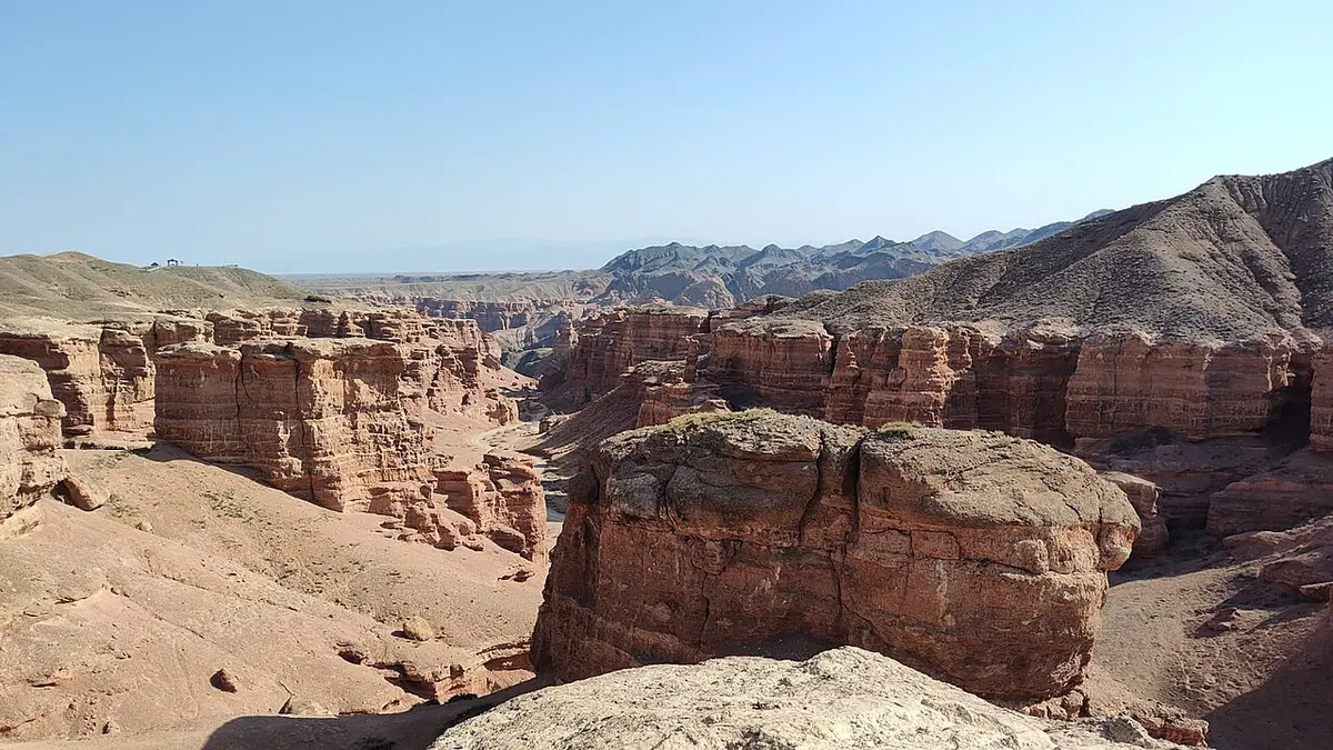 Layers of red sandstone pillars and cliffs in Charyn Canyon