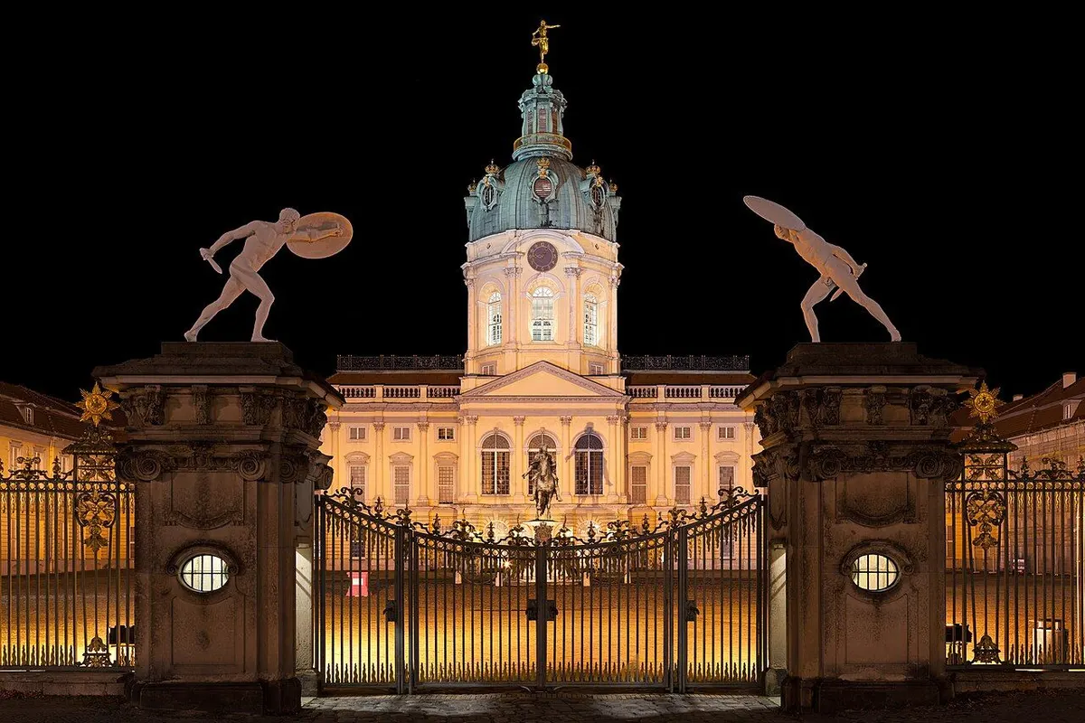 The illuminated south front of Charlottenburg Palace in Berlin at night.