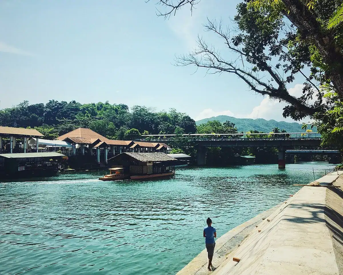 The Loboc River flowing between green jungle banks in sunlight