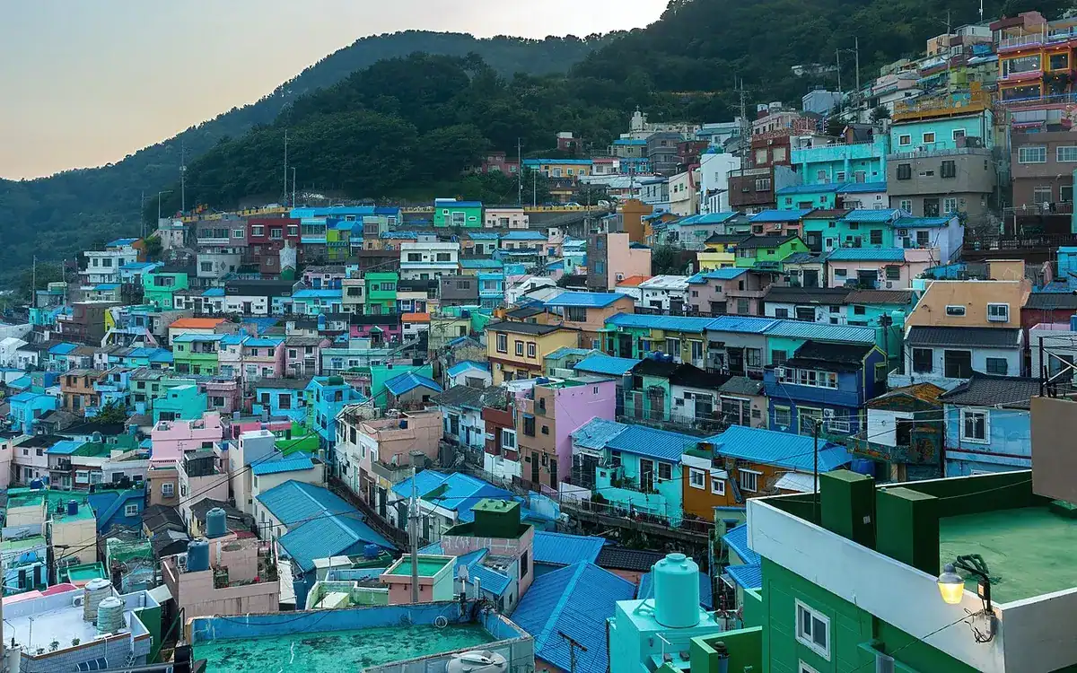 Colorful houses packed along the hillside of Gamcheon Culture Village at sunset