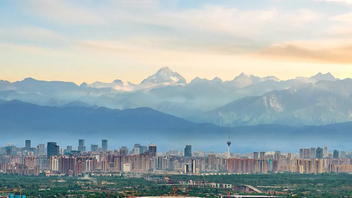 Chengdu's high-rises with the snow-capped peaks of Mount Siguniang beyond