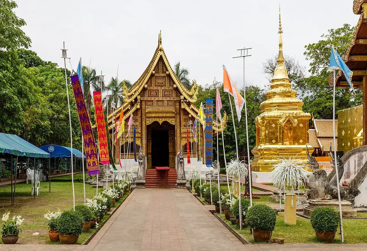 Exterior of a Wat Phra Singh hall with layered Lanna-style roofs