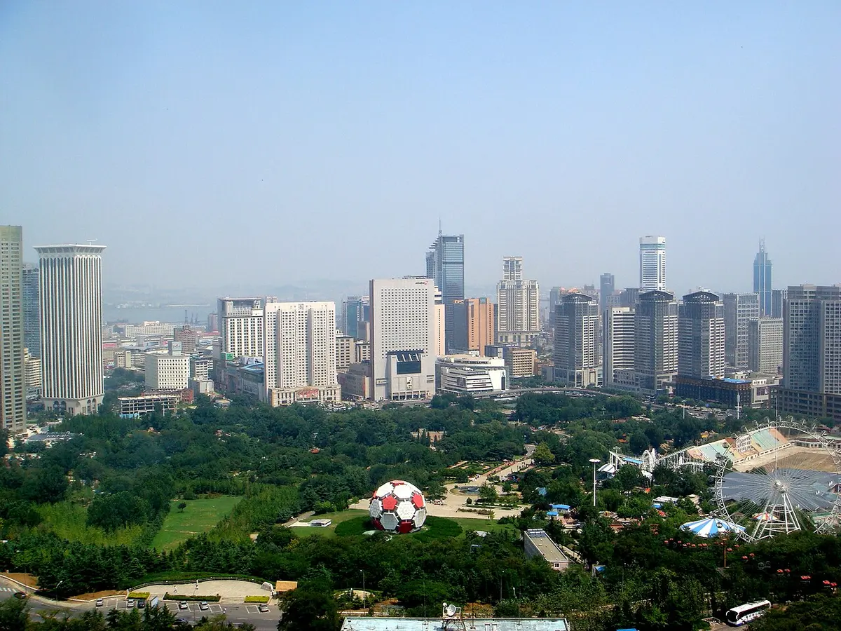 Downtown Dalian's high-rises rising beyond green parkland