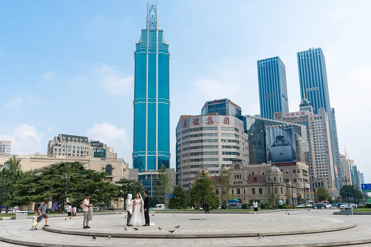 Early-20th-century buildings of Zhongshan Square in Dalian, with modern towers rising behind