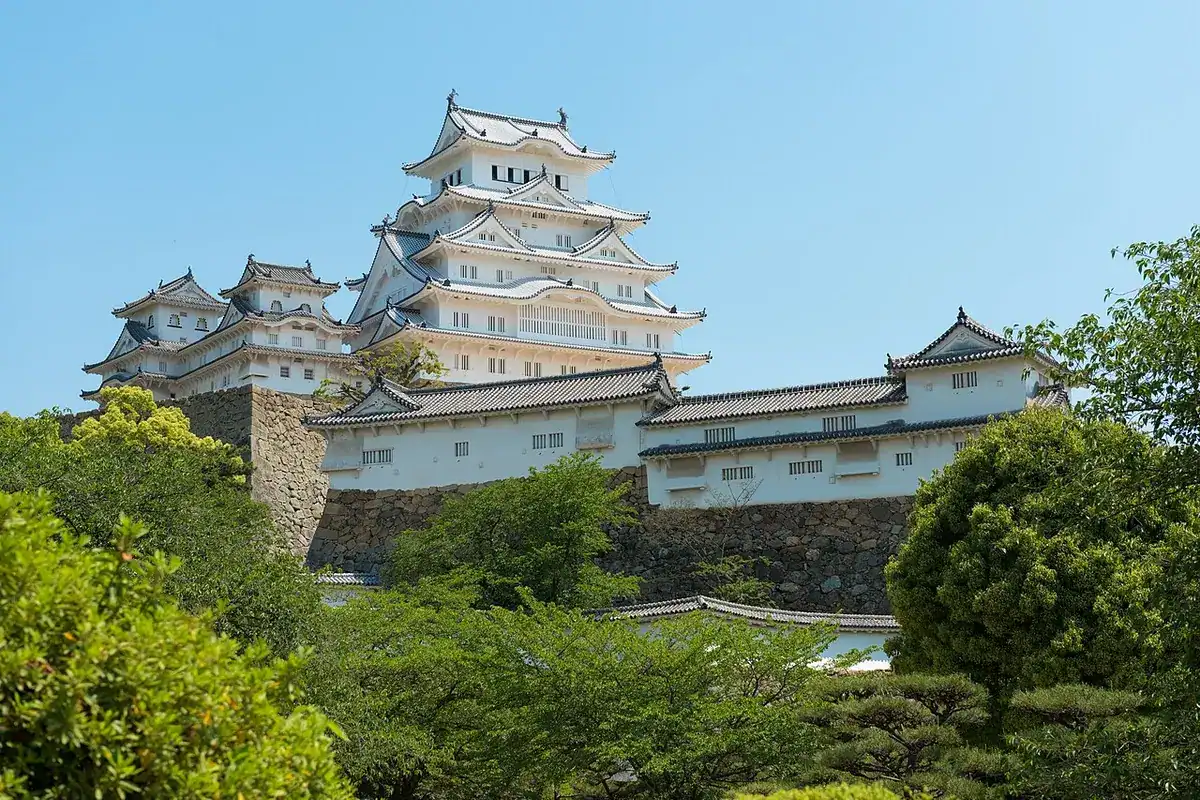 The white-plastered keep of Himeji Castle under a blue sky after its restoration.