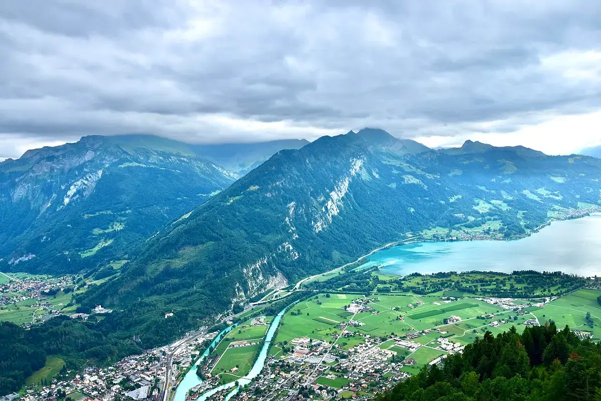 Interlaken and Lake Thun surrounded by mountains, seen from Harder Kulm