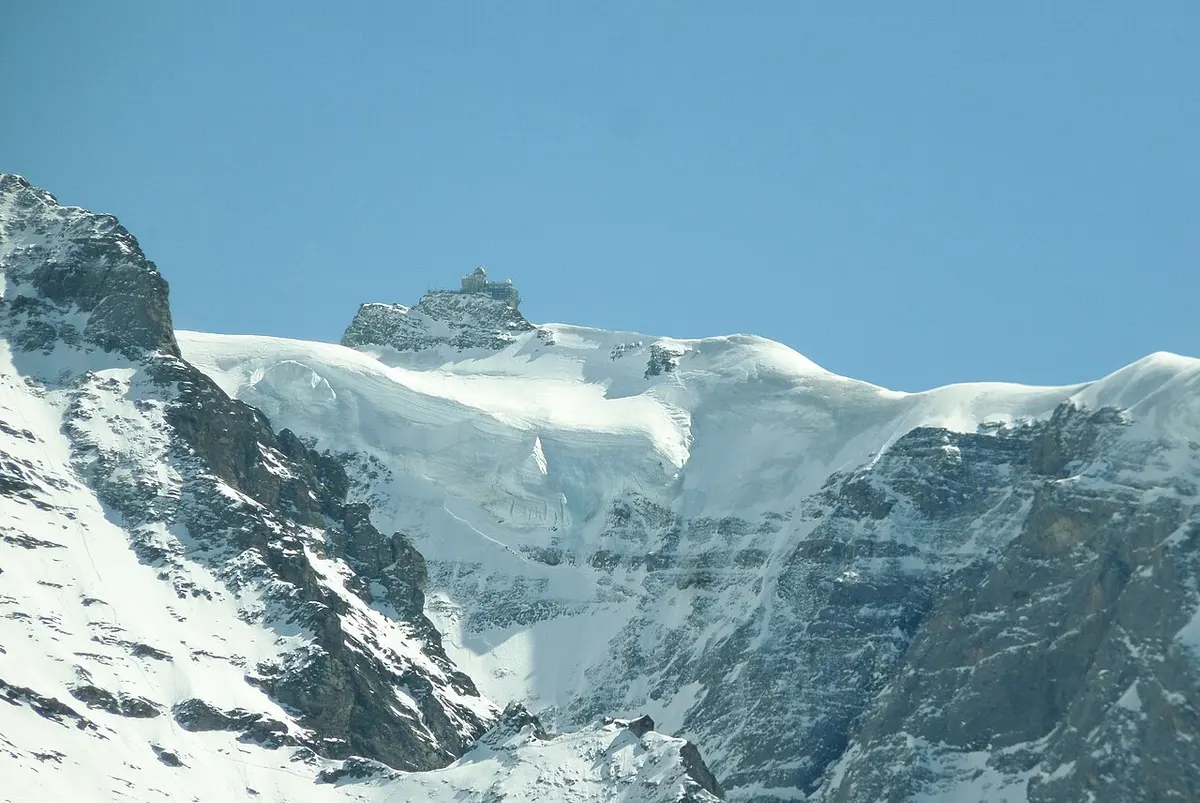 The snowy Jungfraujoch ridge and the Sphinx Observatory seen from Kleine Scheidegg