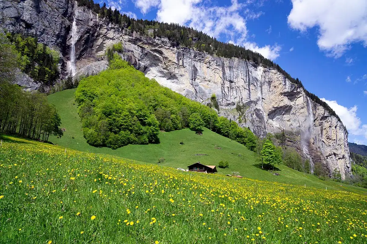 A morning view of the Lauterbrunnen valley, with waterfalls dropping from the cliffs