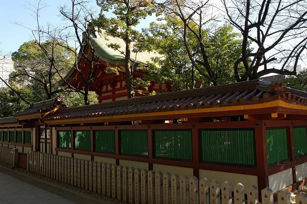A vermilion building of Ikuta Shrine in daylight