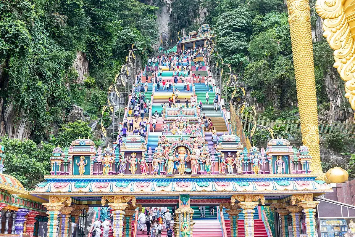 The long stairway of Batu Caves leading up to the cave entrance in the limestone cliff