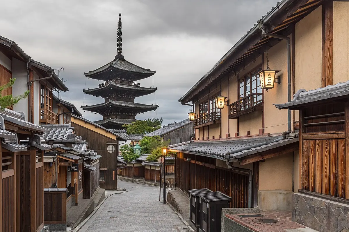 A five-storey pagoda at the end of empty Yasaka-dori with street lanterns lit in the early morning