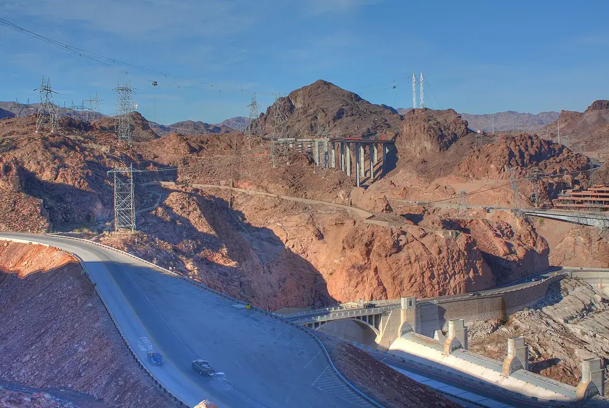 The massive concrete arch of Hoover Dam spanning the canyon