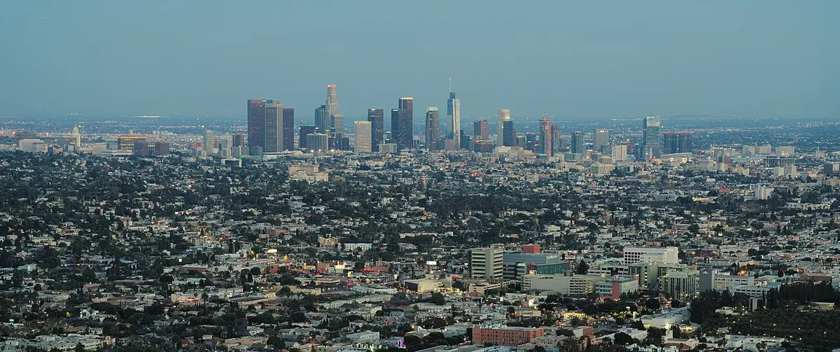 Downtown LA's towers and the sprawling city seen from the hills on a hazy day