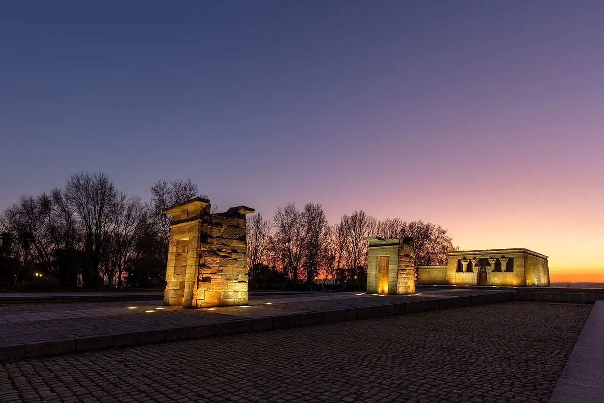 The Temple of Debod and its gateways lit at dusk against the sunset glow