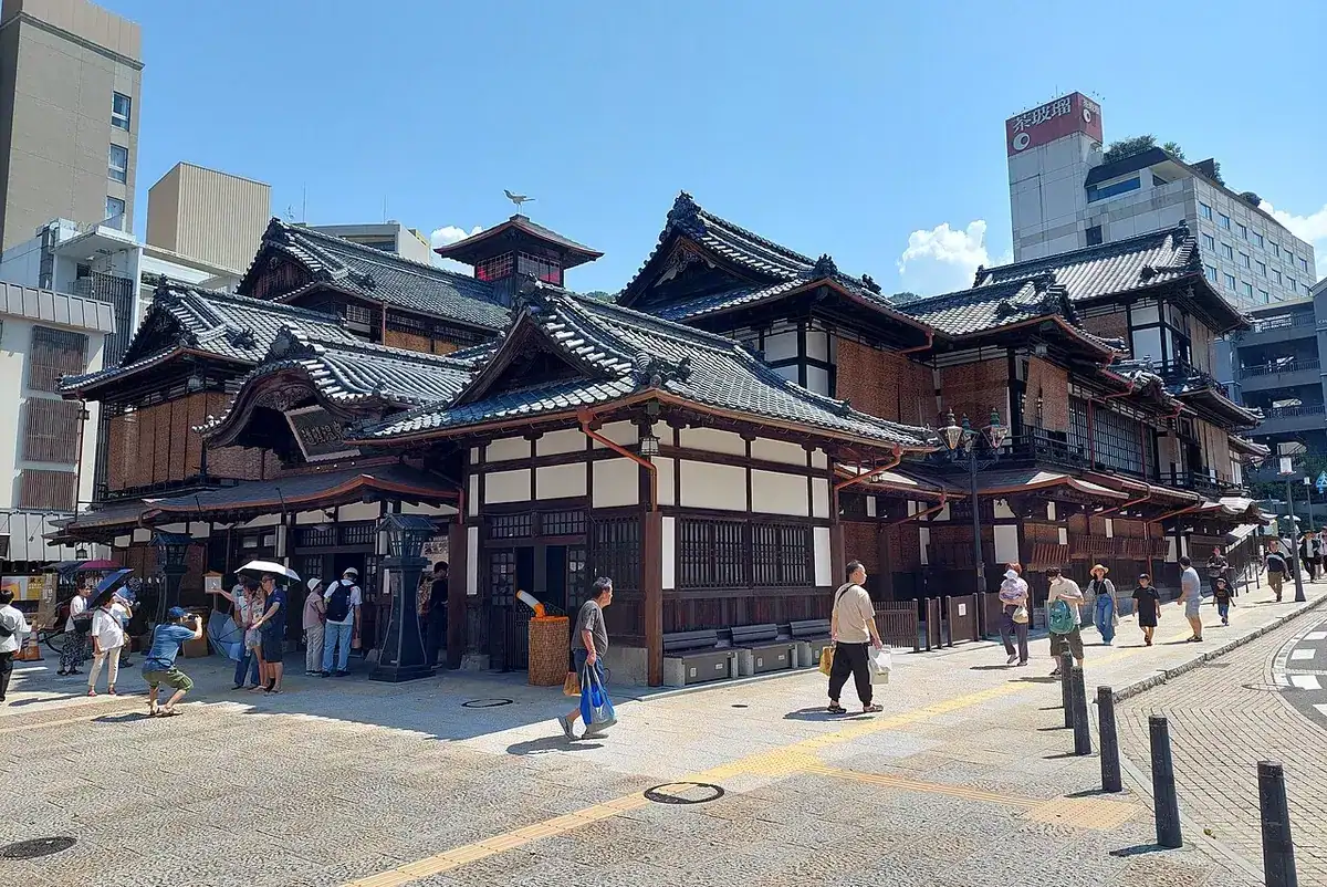 The tiered wooden roofs of the Dogo Onsen Honkan bathhouse.