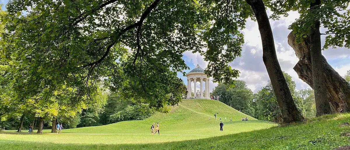 Green lawns of the English Garden and the round Monopteros temple on its hill