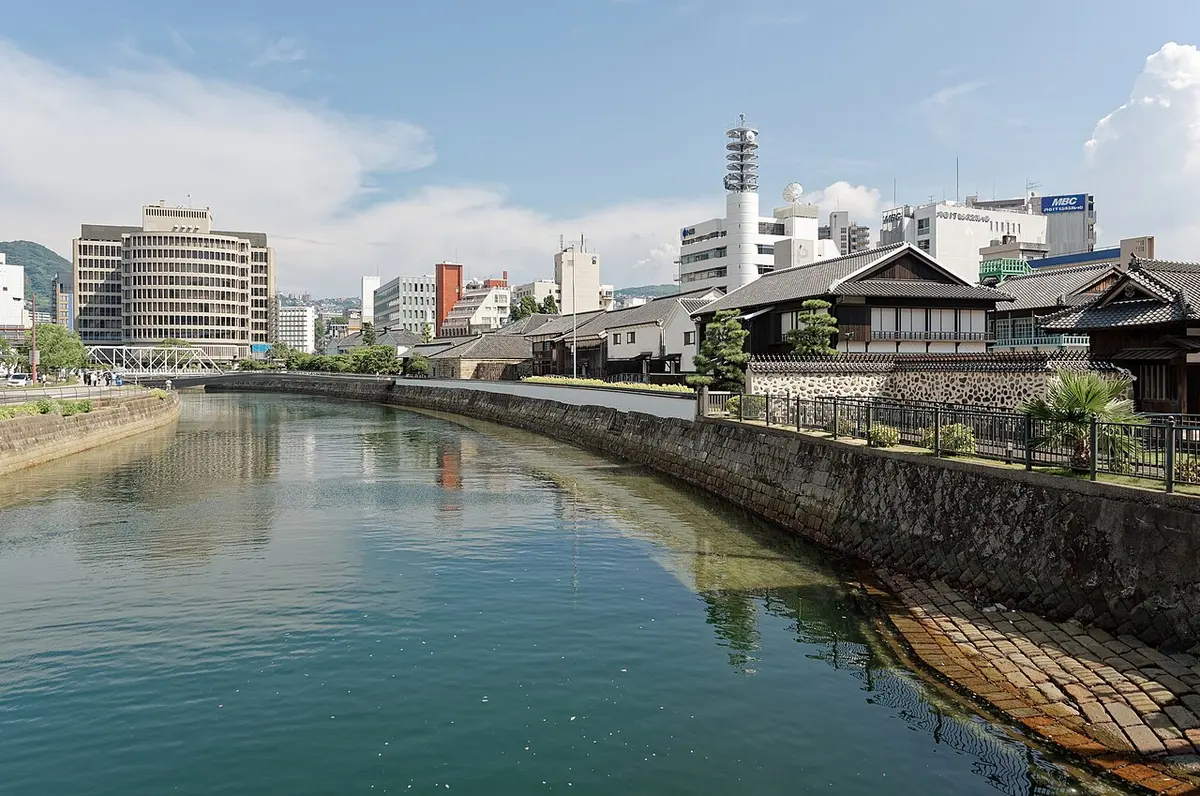 Restored Dutch trading-post buildings on Dejima across the Nakashima River, seen from Tamae Bridge.