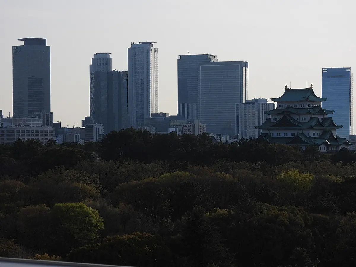 Nagoya Castle's keep with the high-rises around Nagoya Station behind it