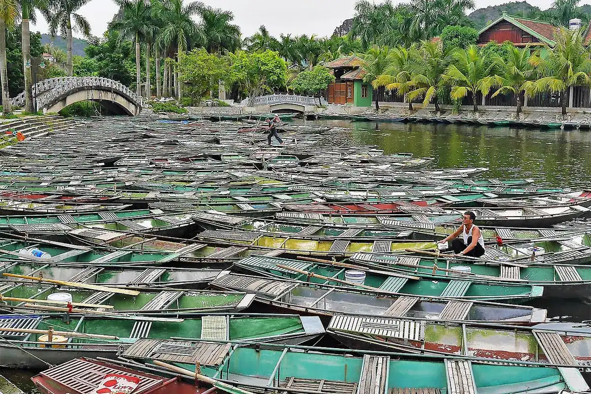 Rows of small rowing boats moored on the river at Tam Coc
