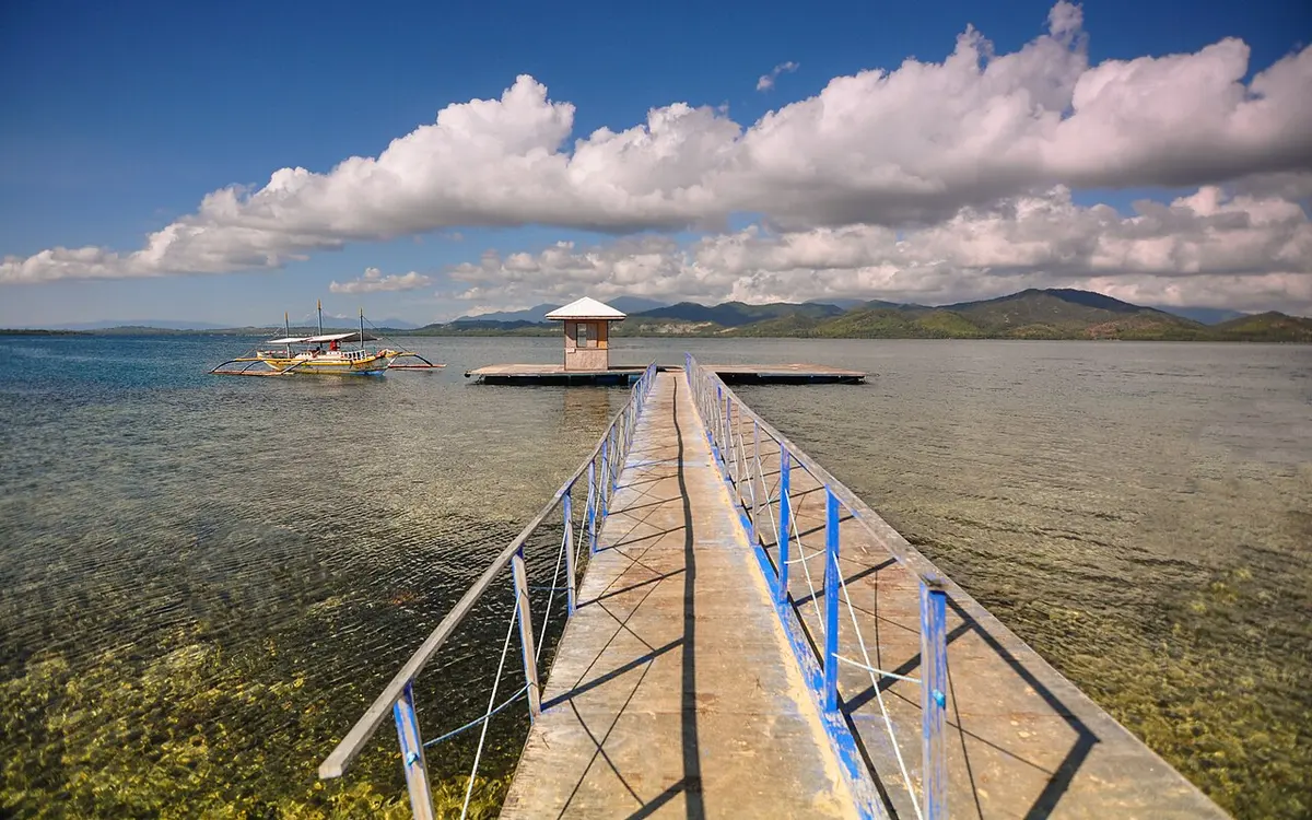 A long jetty over the clear shallow water at Luli Island, Honda Bay