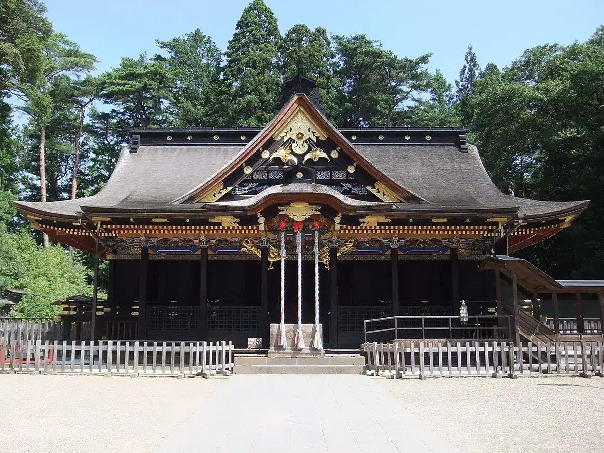 The black-lacquered, gold-decorated worship hall of Osaki Hachimangu