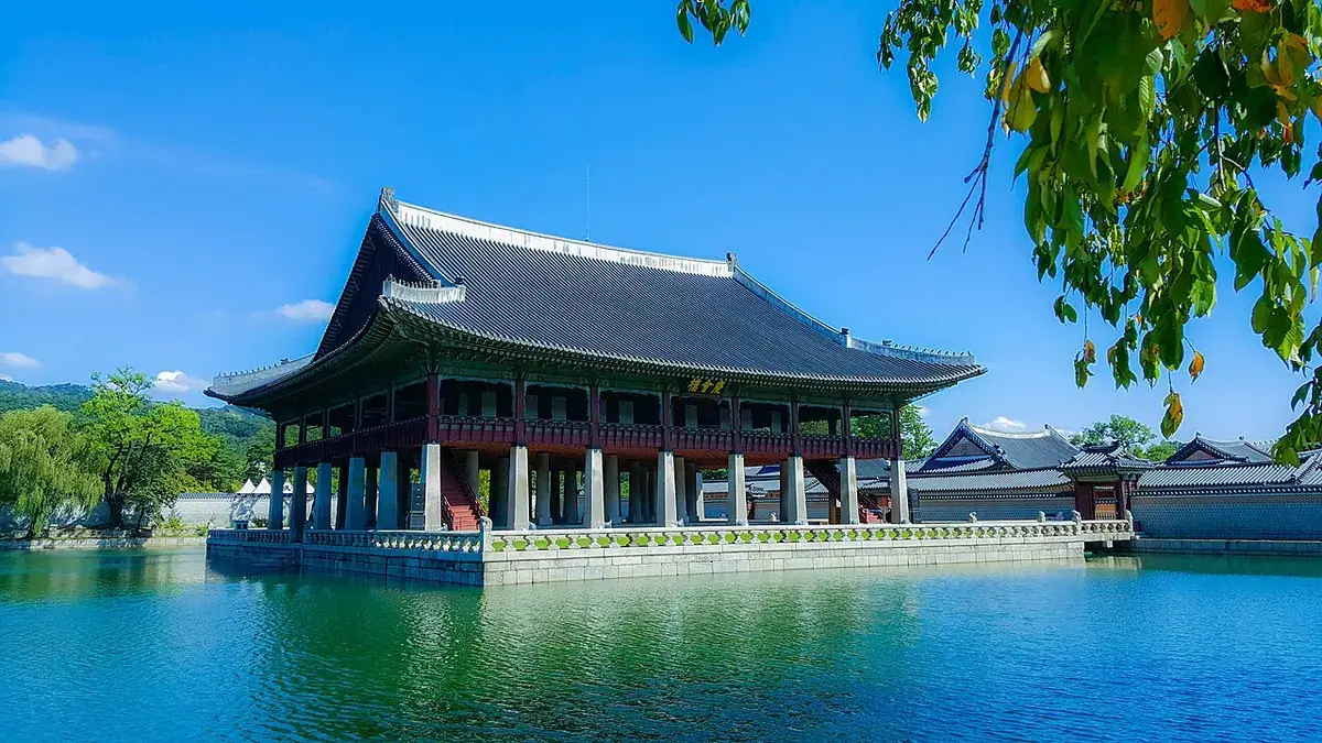 Gyeonghoeru Pavilion standing over the pond at Gyeongbokgung Palace under a blue sky