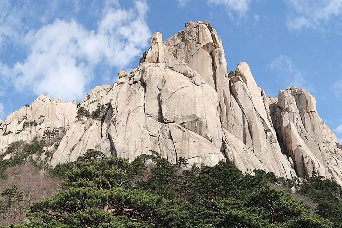 The granite peaks of Ulsanbawi rising above pine forest in Seoraksan.