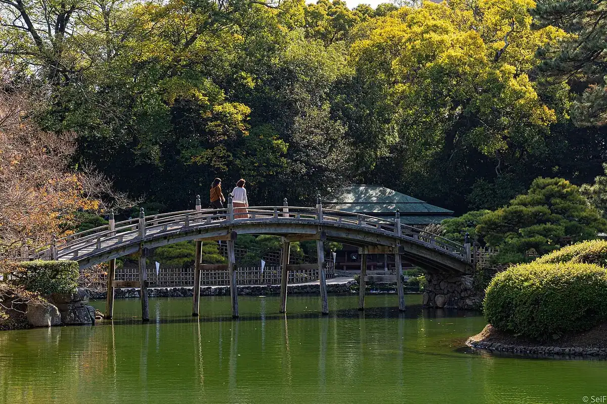 The arched Engetsu-kyo bridge over a pond in Ritsurin Garden.