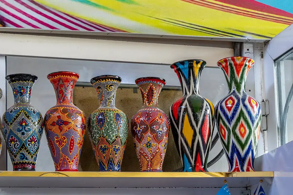 Brightly painted ceramic vases on a shelf at Chorsu Bazaar in Tashkent.