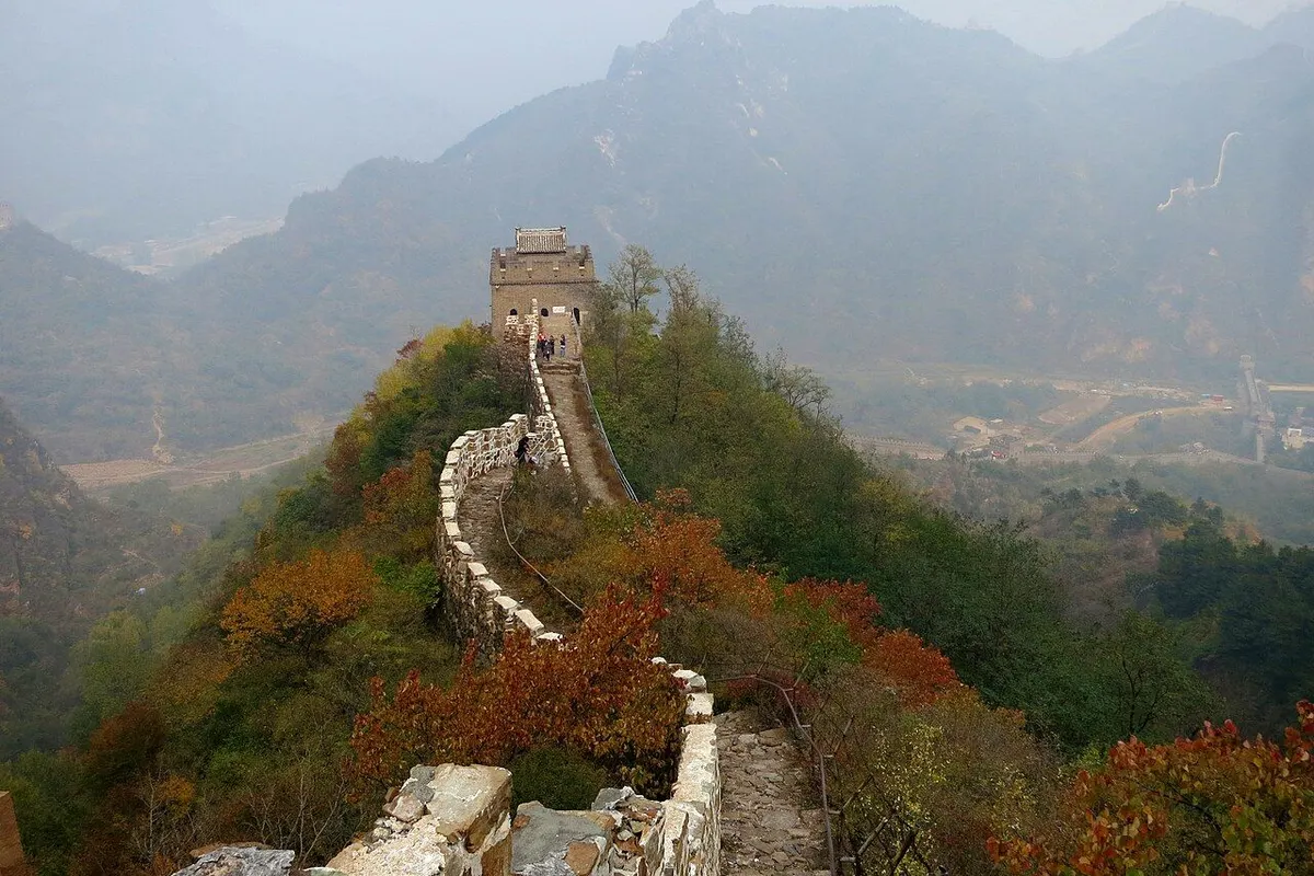 The Huangyaguan Great Wall and a watchtower winding along an autumn ridge.