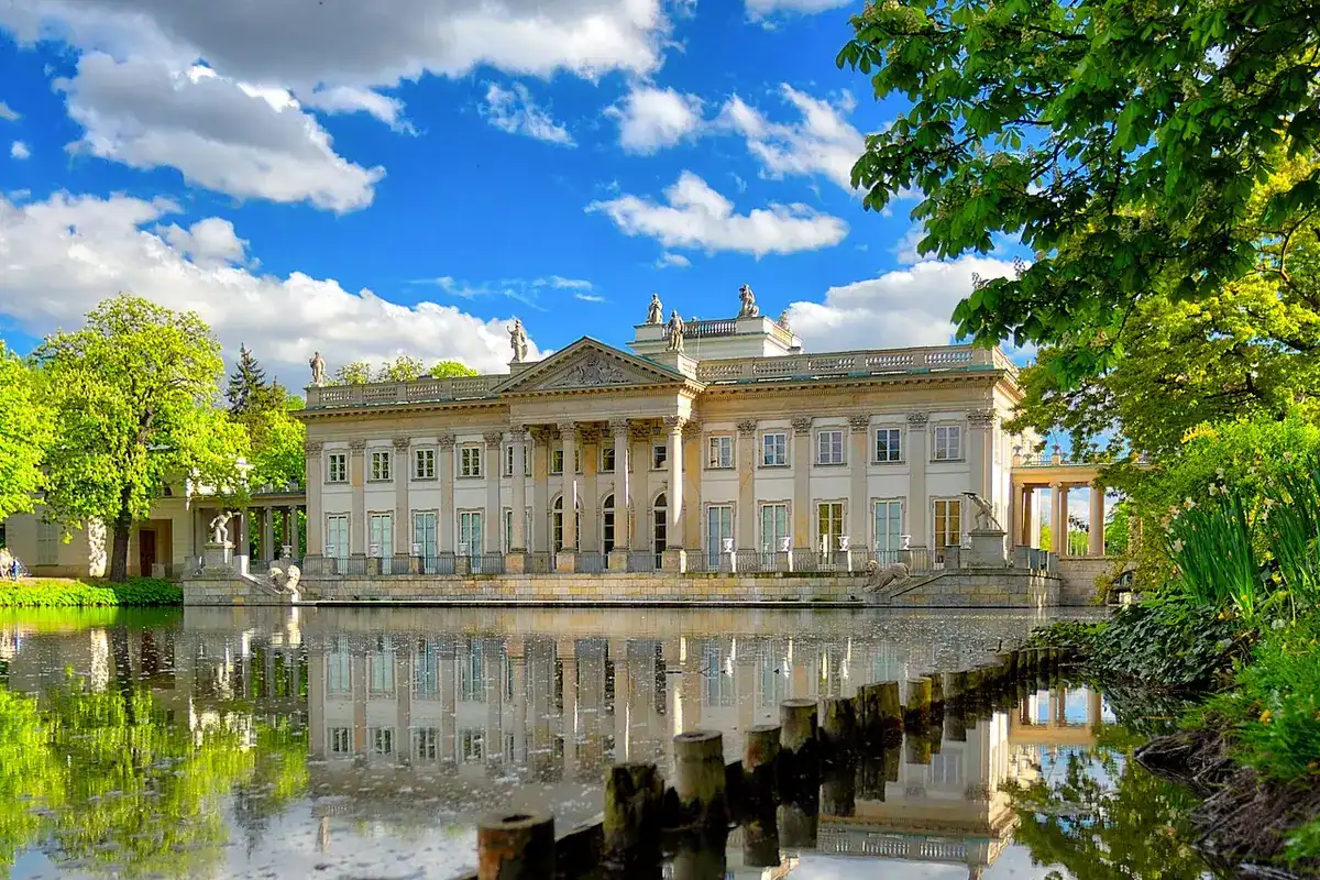 The north façade of the classicist Palace on the Isle in Royal Łazienki Park, reflected in the pond.