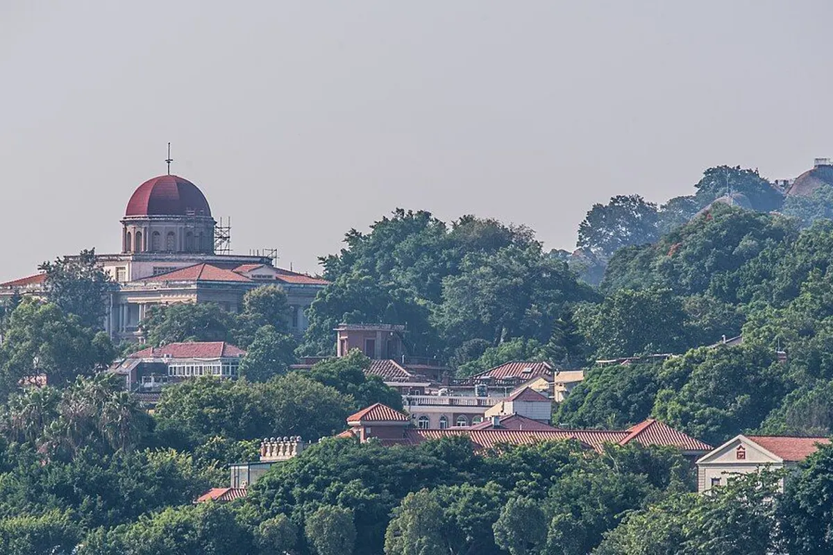 Kulangsu with a red-domed building and old red-roofed villas among the trees.