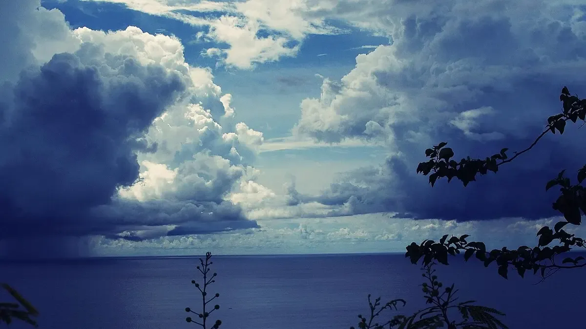 Rain clouds gathering over the deep-blue sea off Tumon Bay, Guam