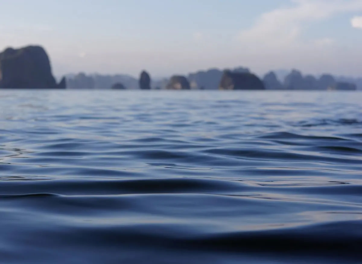 Limestone karst islands rising from the water in Ha Long Bay