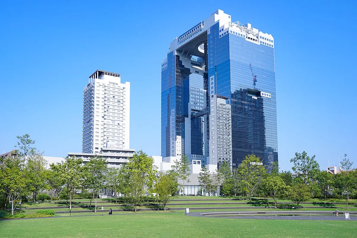 The twin towers of the Umeda Sky Building, joined at the top, seen from Grand Green Osaka.