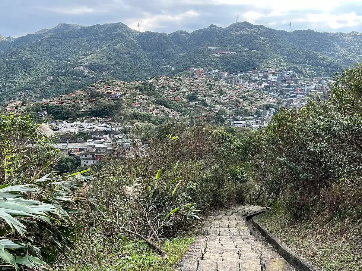 The hillside town of Jiufen spread across the slope, seen from Mt. Keelung.