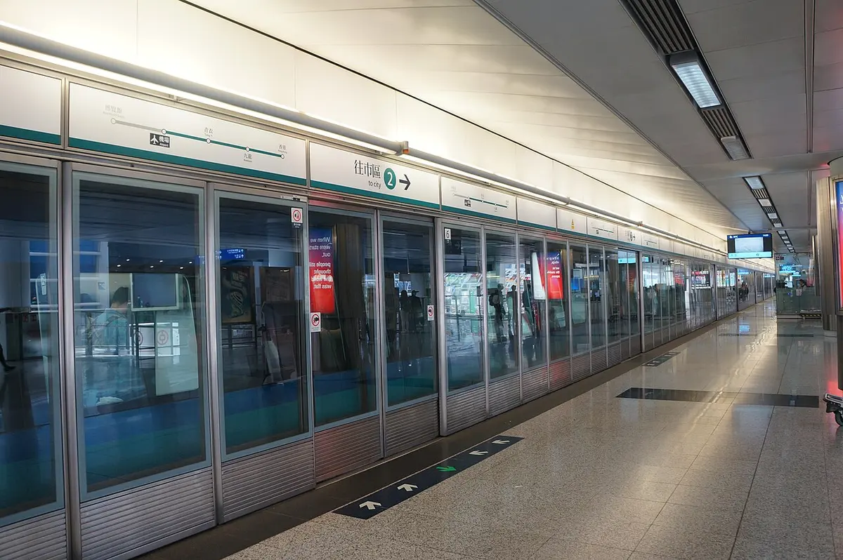 The wide, bright platform of an airport rail link station connecting the airport with the city.