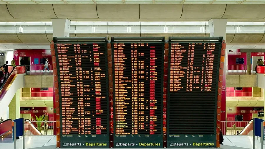 An airport departures board listing a long run of cancelled and delayed flights.