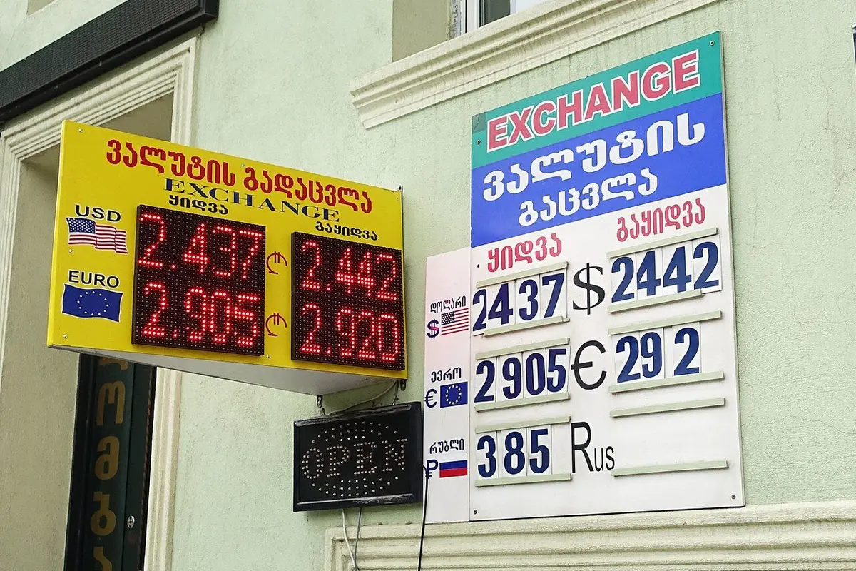 Exchange-rate boards showing buy and sell rates for foreign currencies.