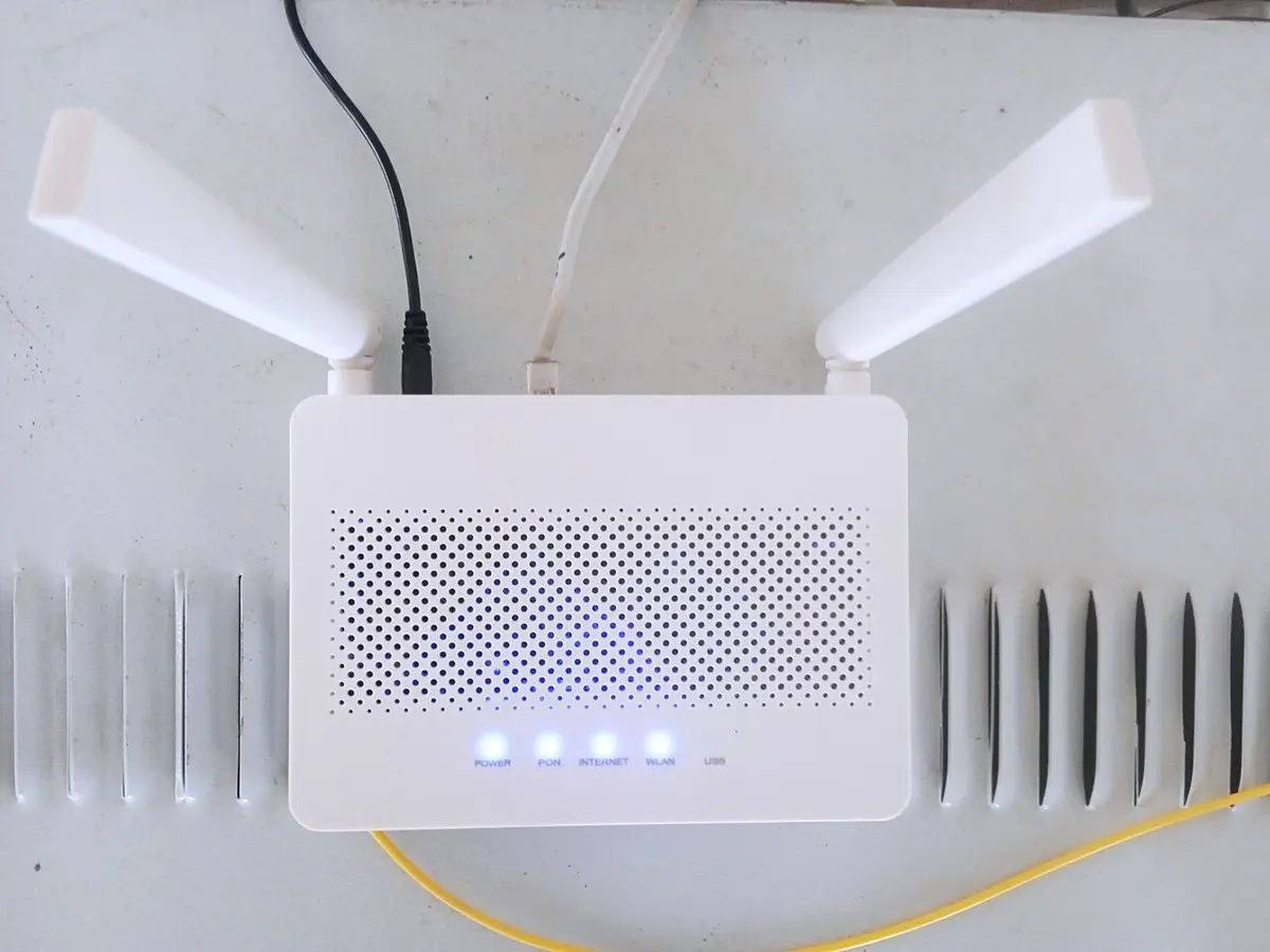 A white Wi-Fi router with two antennas.