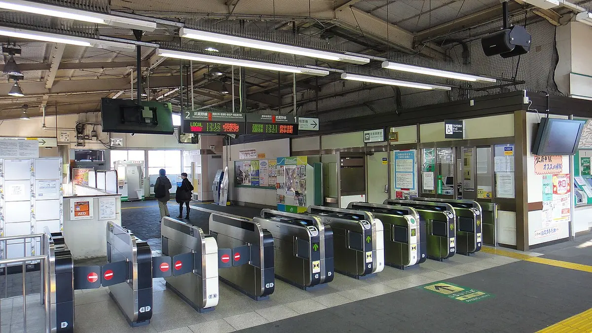 A row of automatic ticket gates at a train station in Japan.