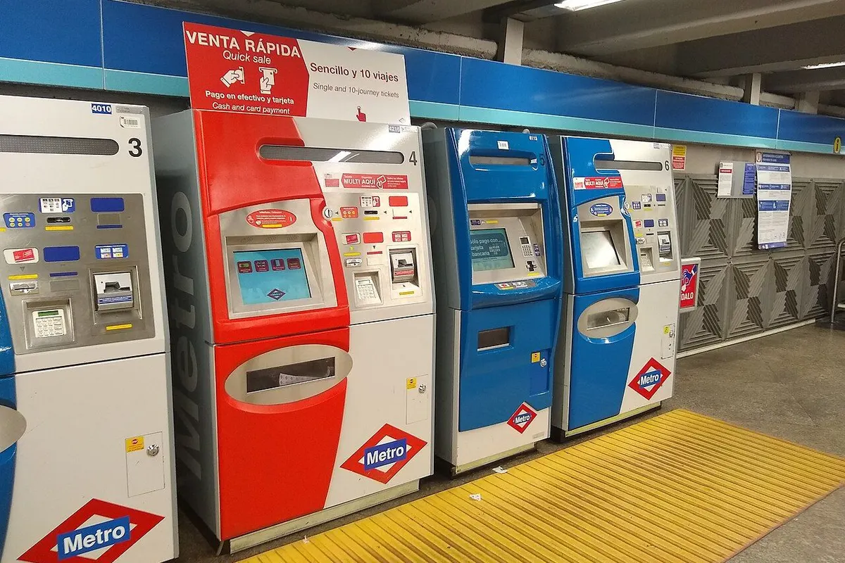 A row of ticket vending machines in a metro station.