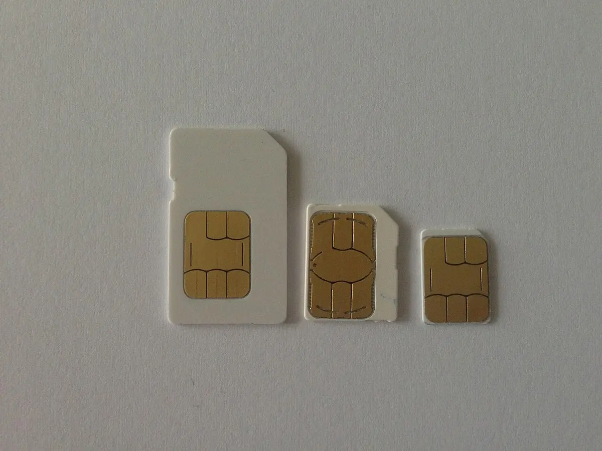 Three SIM cards in mini, micro and nano sizes laid side by side.