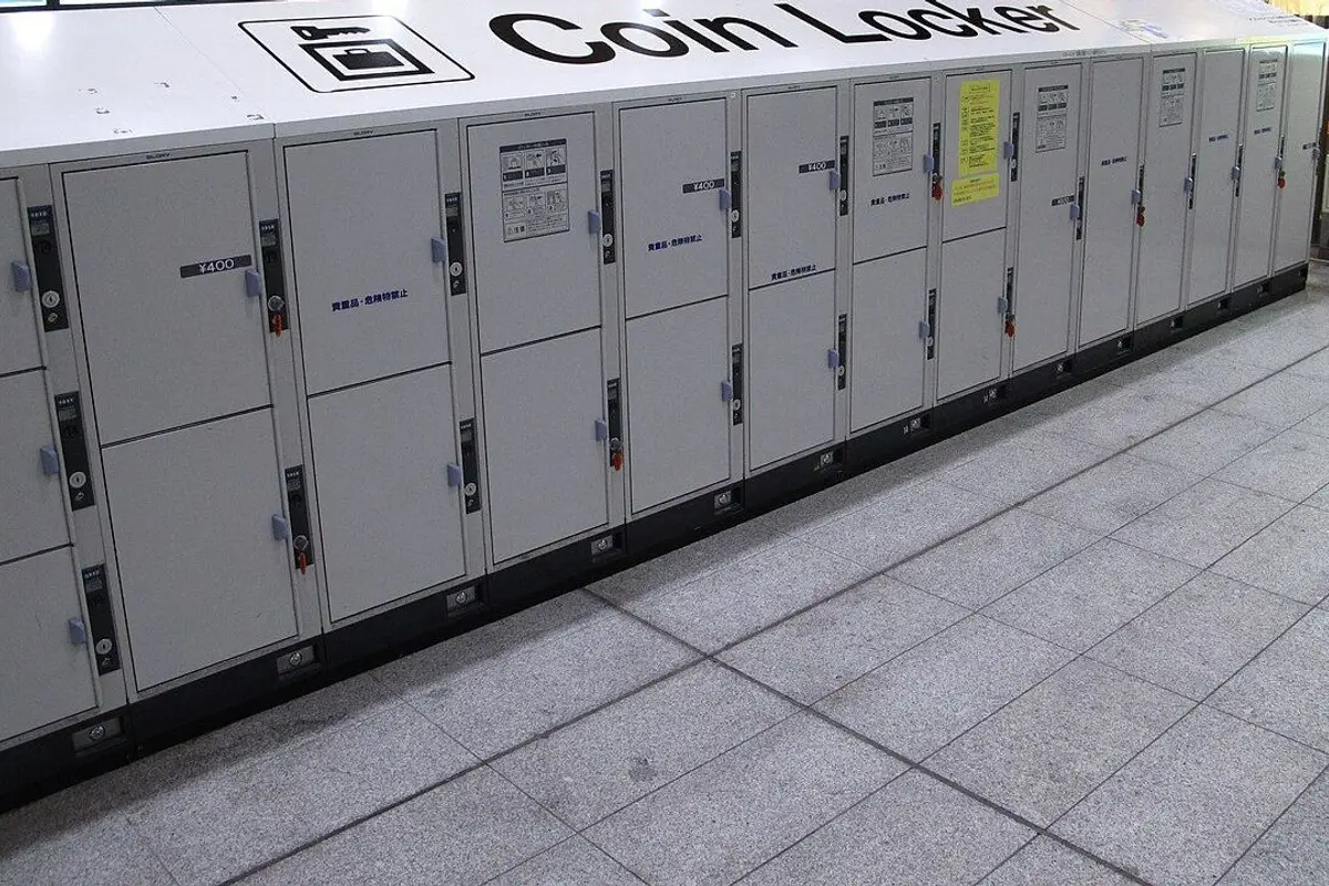 A long row of white coin lockers inside a station.