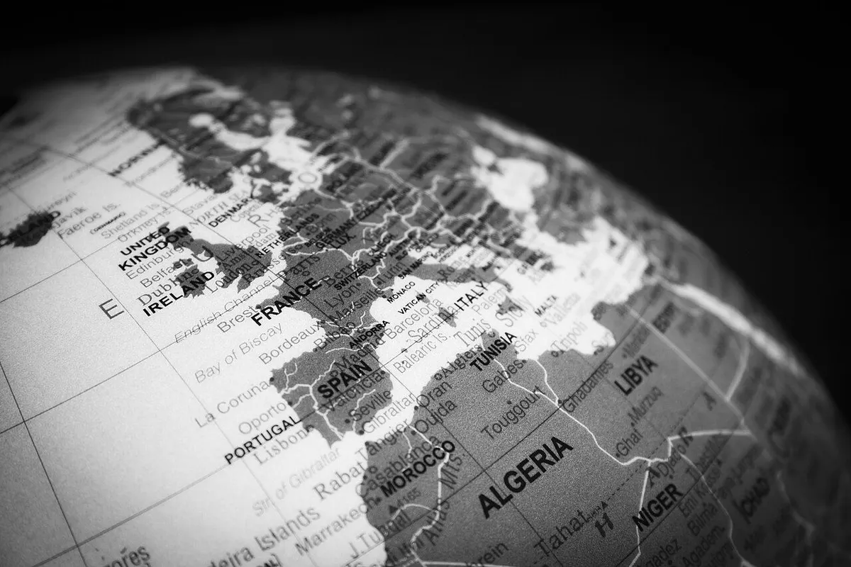 Black-and-white close-up of a globe showing country names and borders.